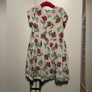 Kid’s white, short sleeved dress w/pink & blue design. Zips in back.